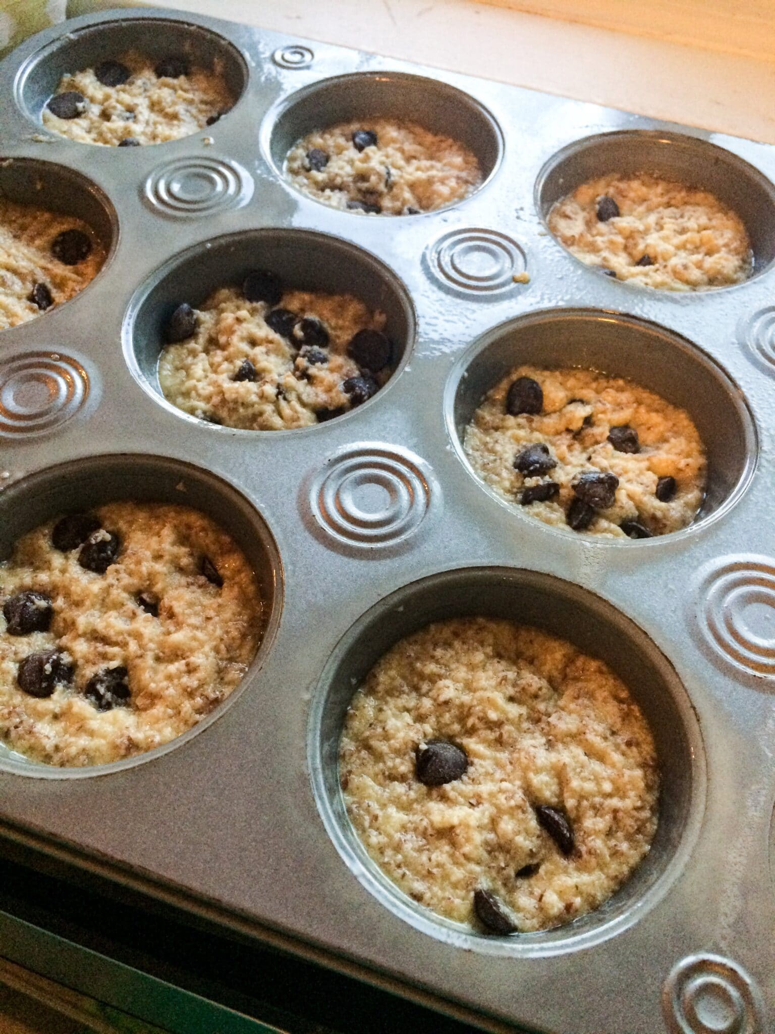 low carb chocolate chip banana bread batter in a muffin tin