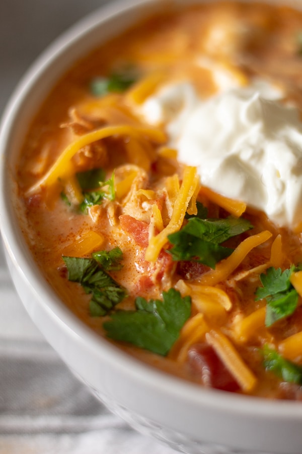 Creamy Chicken taco soup in a white bowl with sour cream