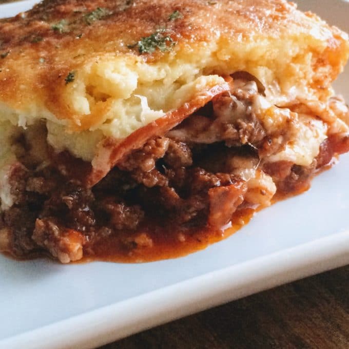 a slice of pizza casserole with a keto crust on a plate