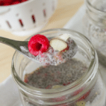 a glass jar full of raspberry almond chia pudding