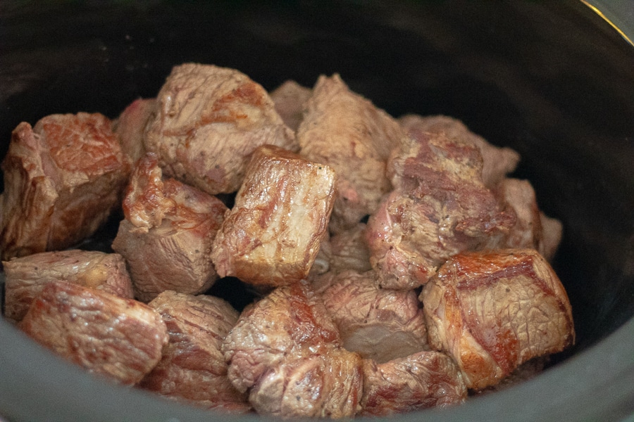 Seared beef chuck in a crock pot for beef Bourguignon