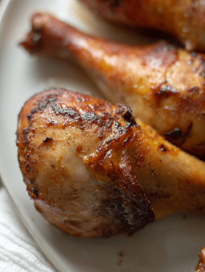 Close up photo of orange and five-spice roasted chicken legs.