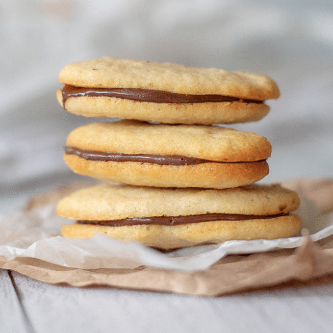 three keto milano cookies stacked on top of each other