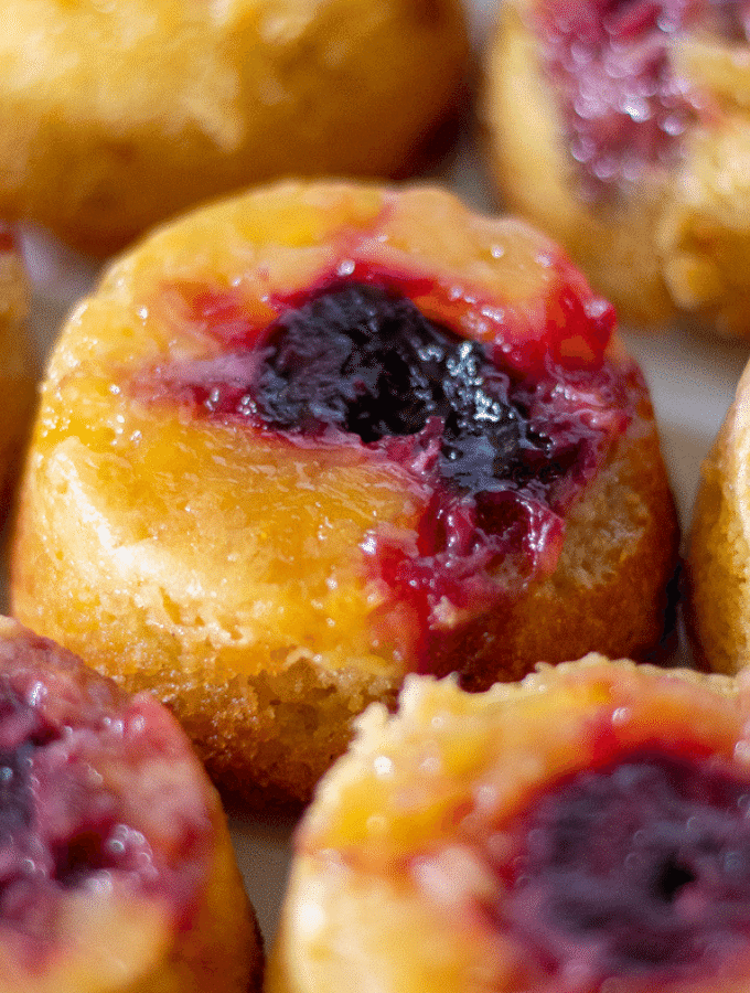 A close up of a plateful of keto pineapple upside down cakes with cherries