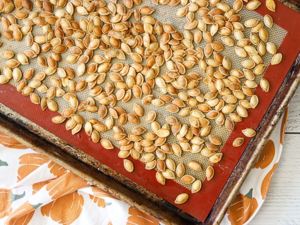 a sheet pan full of roasted pumpkin seeds