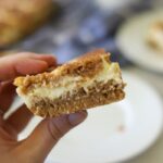 a single snickerdoodle cheesecake bar being held up
