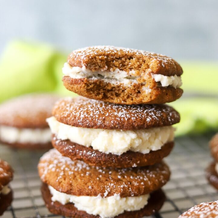 three low carb gingerbread whoopie pies stacked on top of each other.