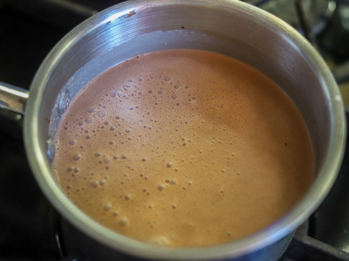 homemade hot chocolate being cooked in a saucepan