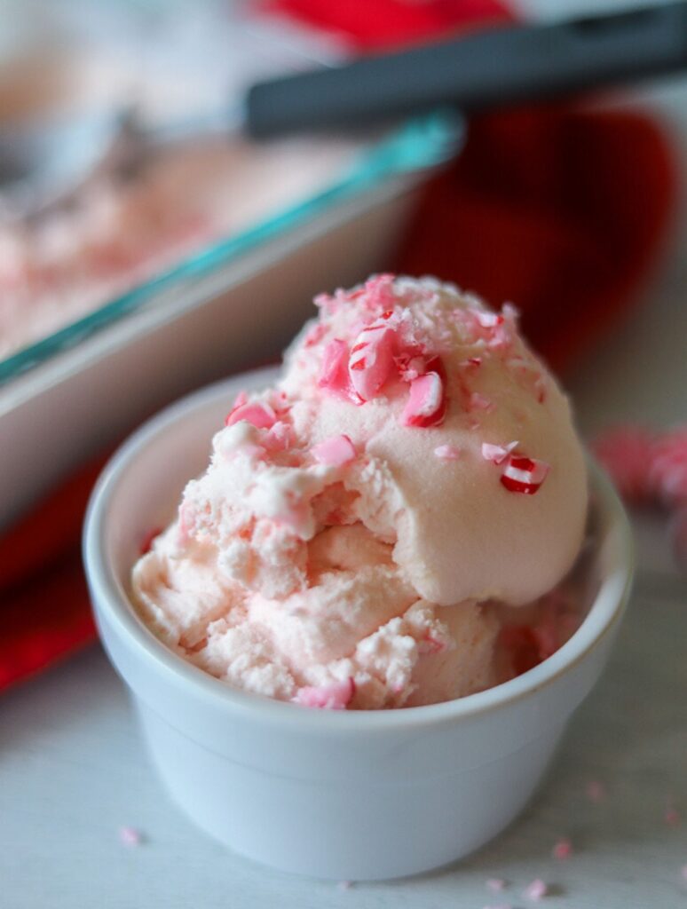peppermint ice cream scooped into a white remekin with crushed peppermints on top