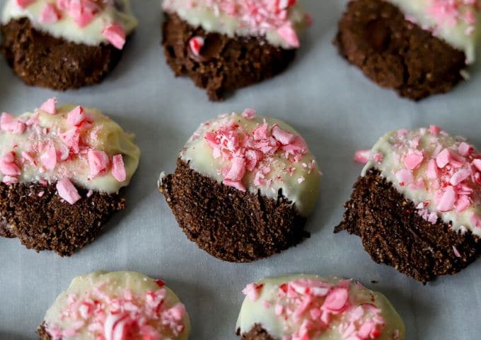 low carb chocolate cookies, half dipped in white chocolate and sprinkled with crushed peppermint