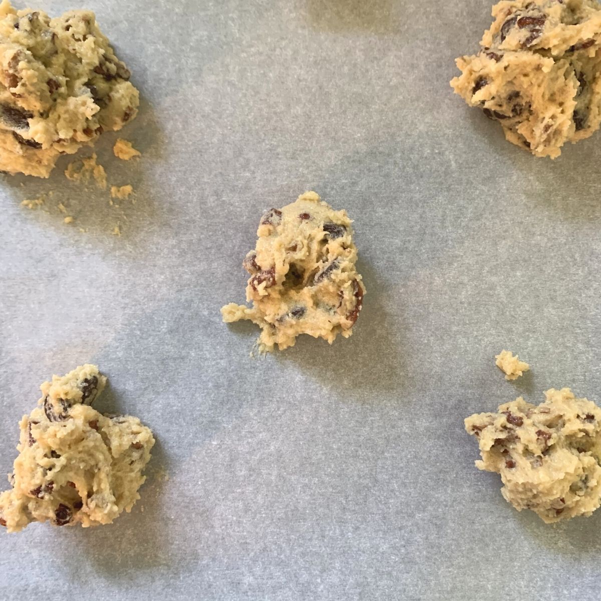 rounded tablespoons of low carb cookie dough on a parchment lined baking sheet before baking