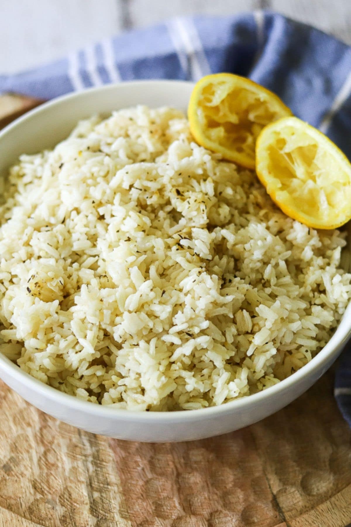Greek Rice seasoned with lemon, garlic, and oregano in a white serving bowl.