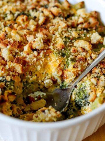 a white casserole dish full of cheesy broccoli