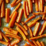 Roasted carrots on a parchment lined baking sheet