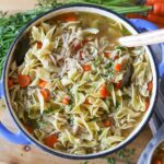 a dutch oven full of homemade chicken noodle soup