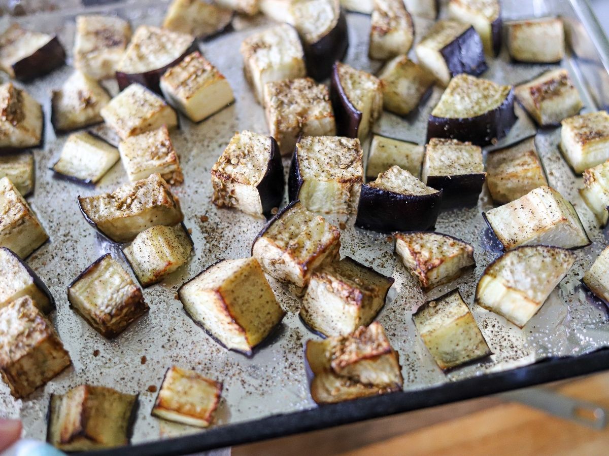 diced eggplant on a baking sheet after roasting