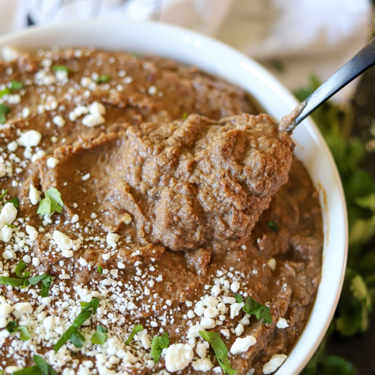 homemade low carb refried beans being served from a bowl