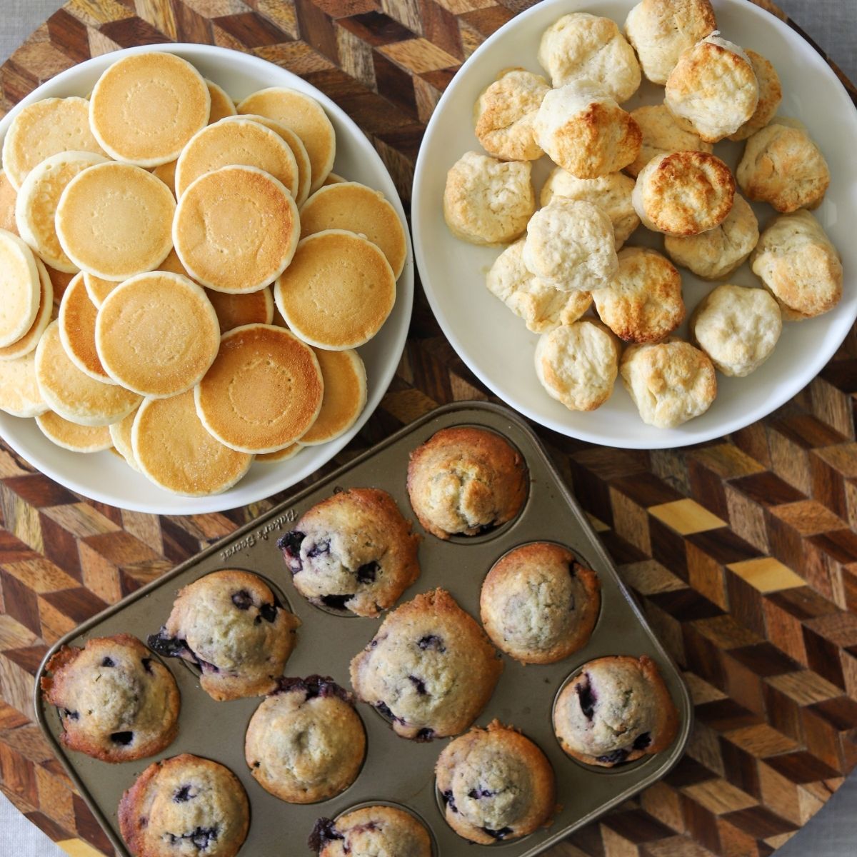 plates full of miniature pancakes, muffins, and biscuits