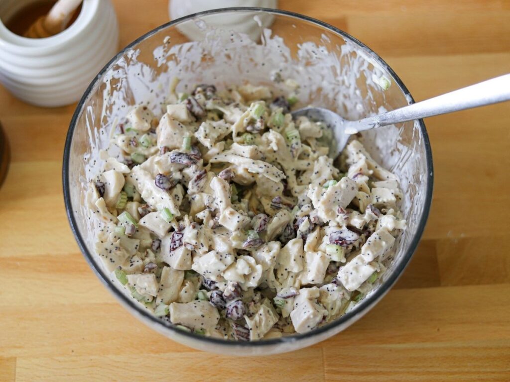 cranberry pecan chicken salad in a bowl after being mixed up