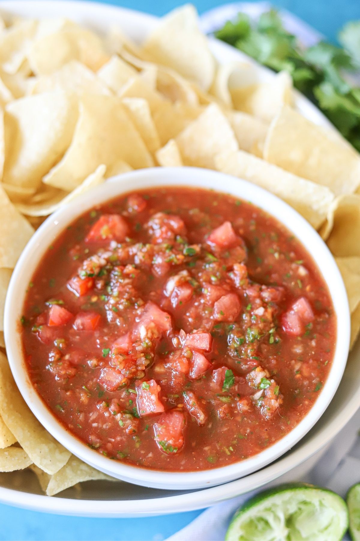 a bowl full of easy homemade salsa surrounded by tortilla chips