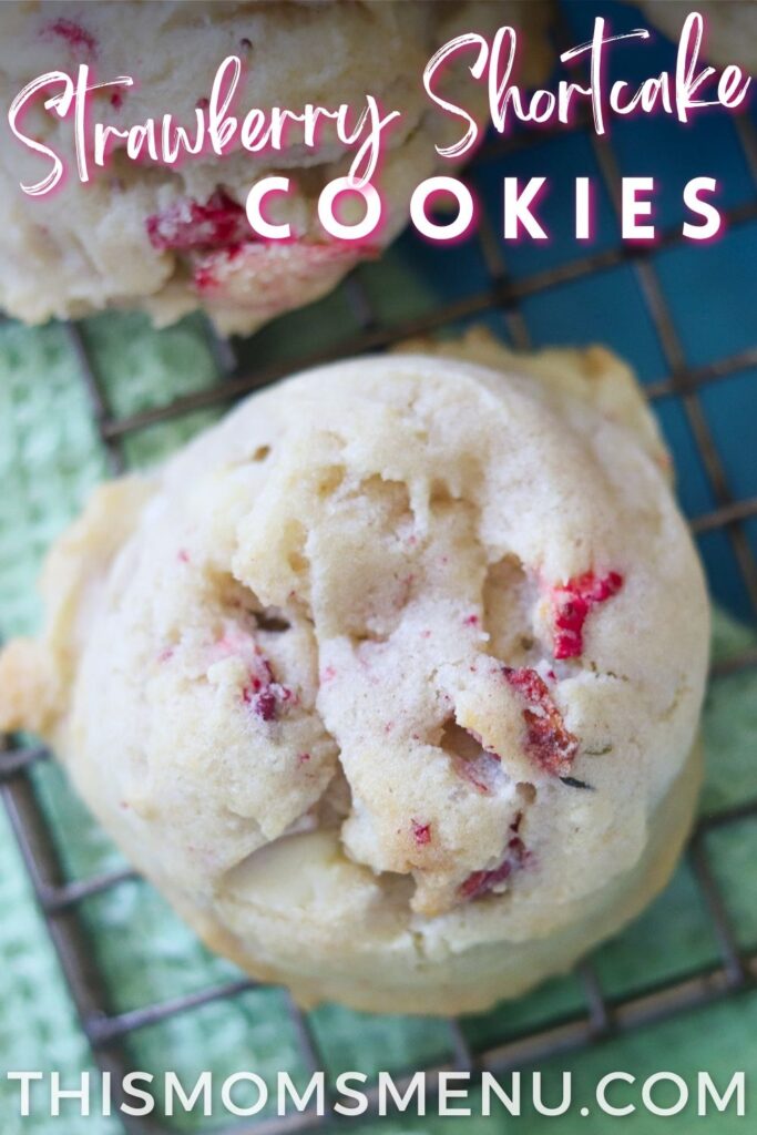 a strawberry cookie on a cooling rack with text overlay