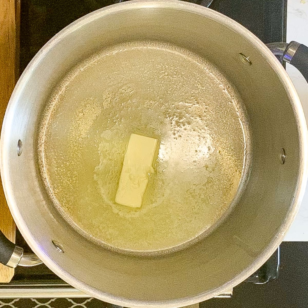 Butter melting in a large pot for homemade s'more treat bas