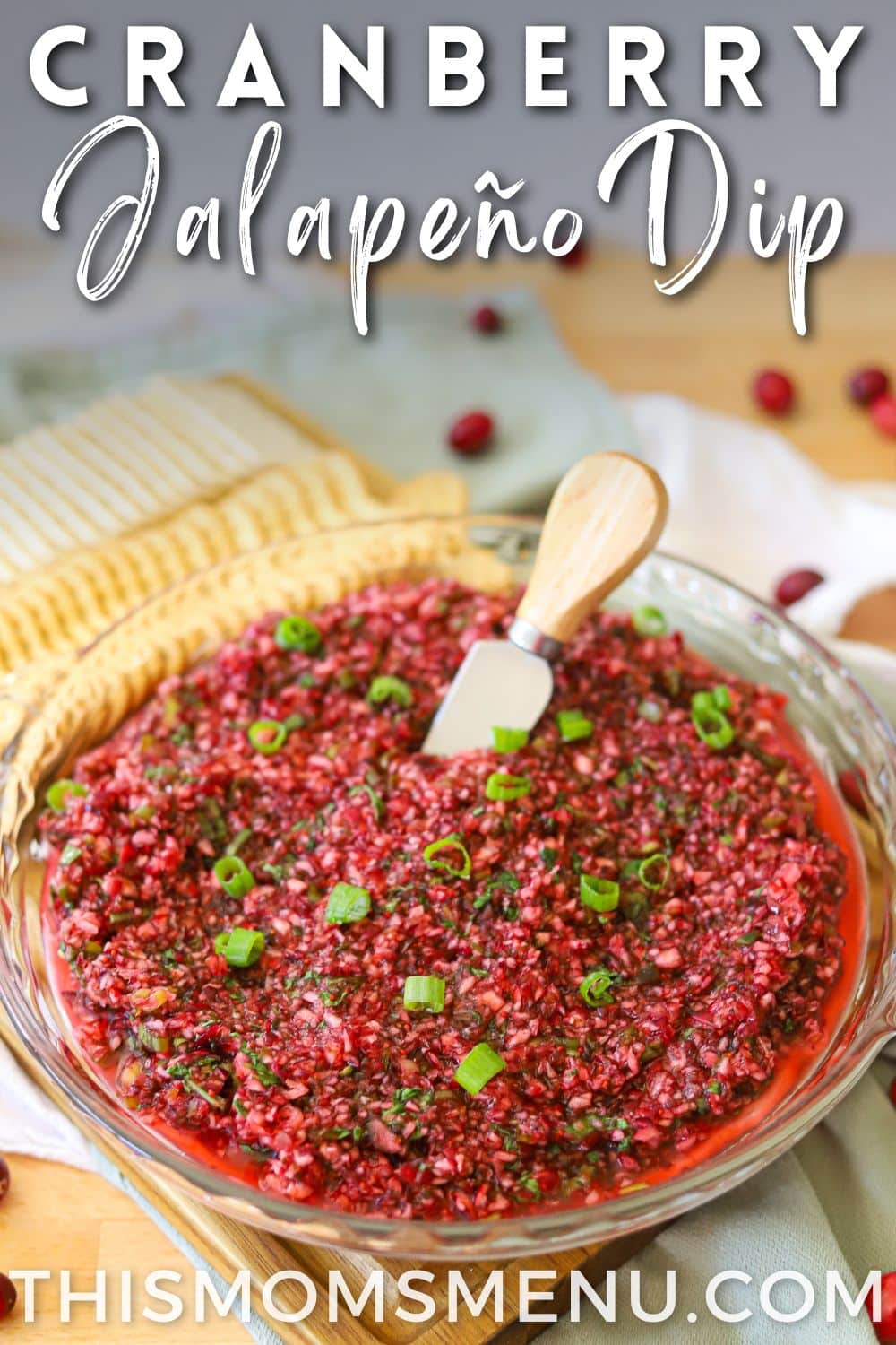 a cranberry dip over cream cheese with a text overlay