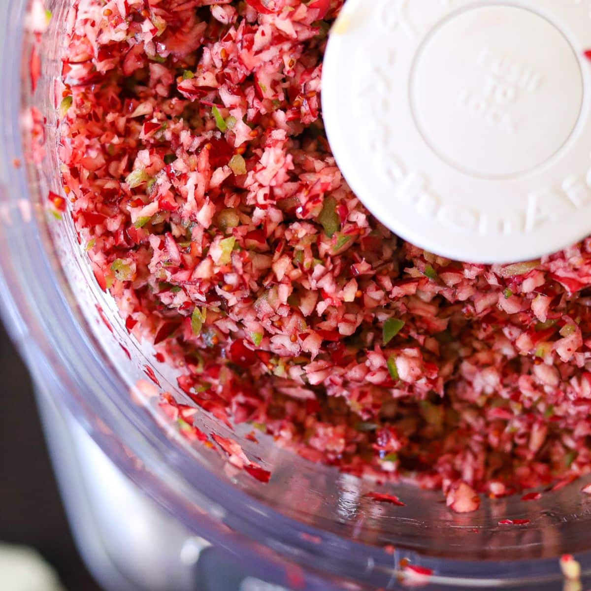 cranberries and jalapenos chopped up together in a food processor