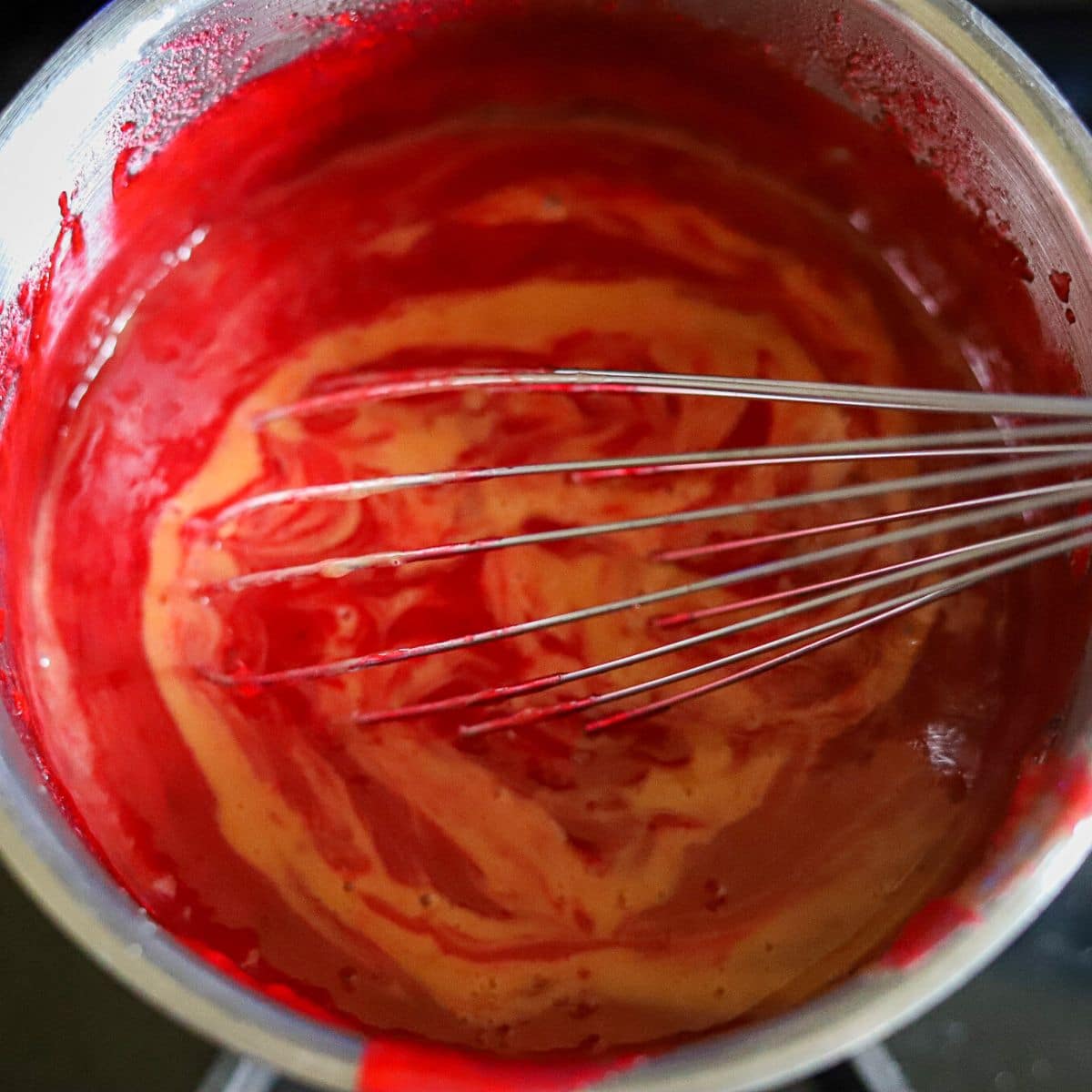 Eggs being whisked into cranberry and lemon puree