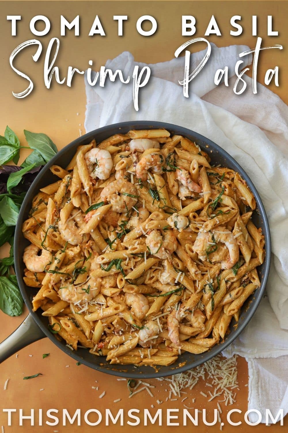 a skillet full of penne pasta and shrimp topped with a creamy tomato basil sauce.
