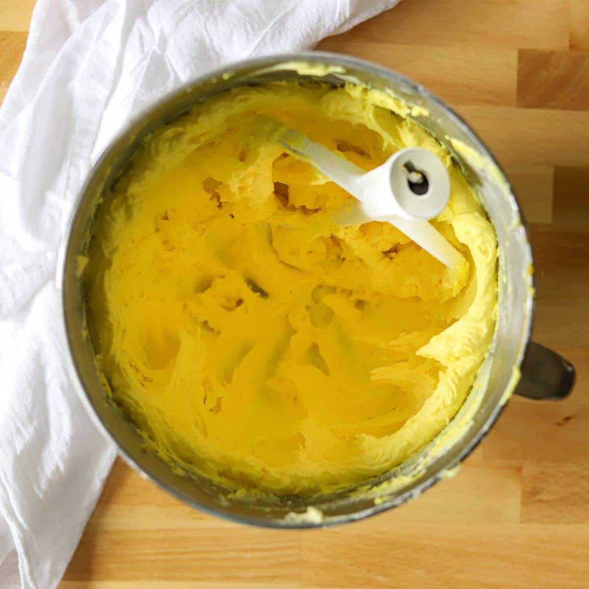 yellow buttercream frosting in a mixing bowl.