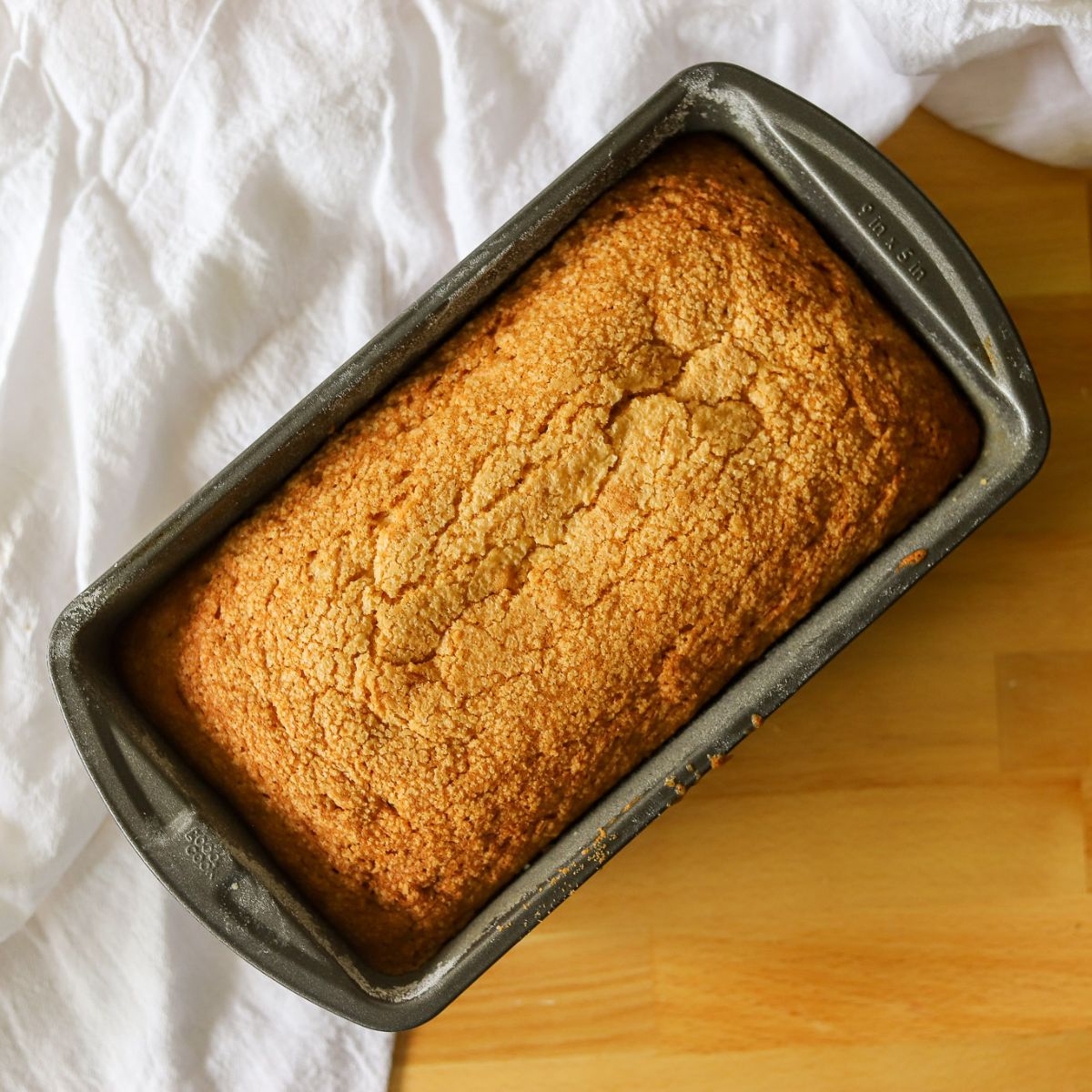 a golden brown pound cake in a loaf pan