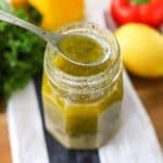 a glass jar filled with homemade Italian dressing