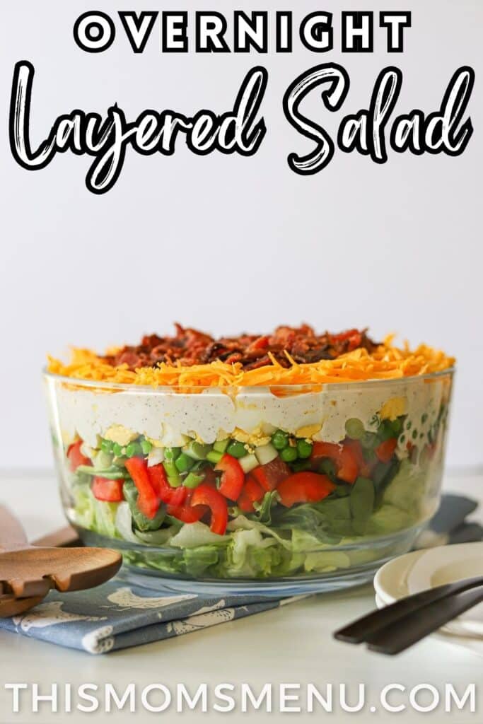 a layered salad in a glass bowl with text overlay