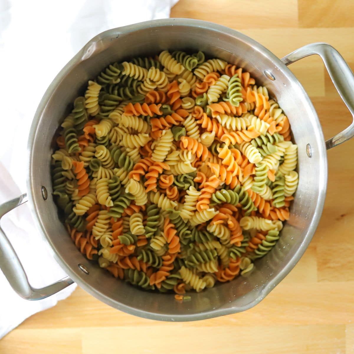 tri color rotini for pasta salad in a large silver pot