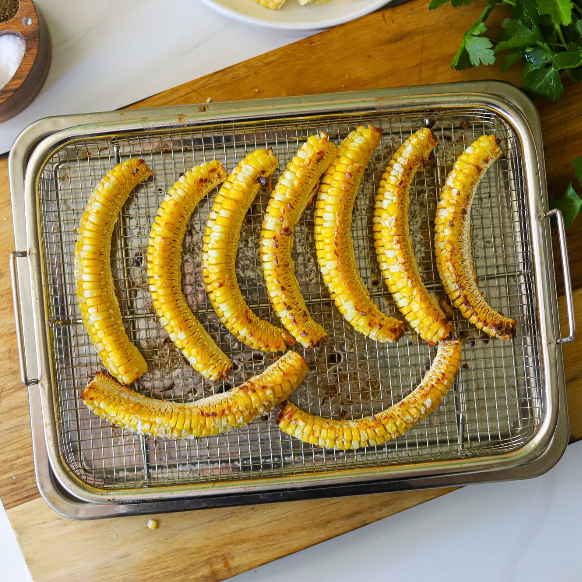 roasted corn ribs on an air fryer tray.